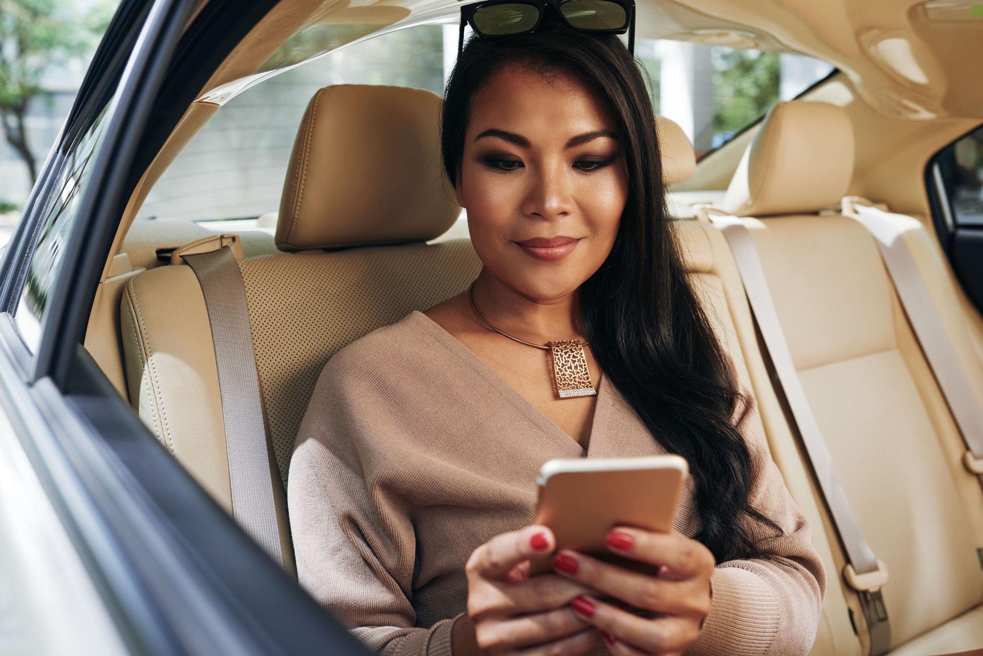 Young Asian Woman Texting On Phone